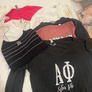 various alpha phi/ucla greek life merch. crop tanks, t shirts, and long sleeves.